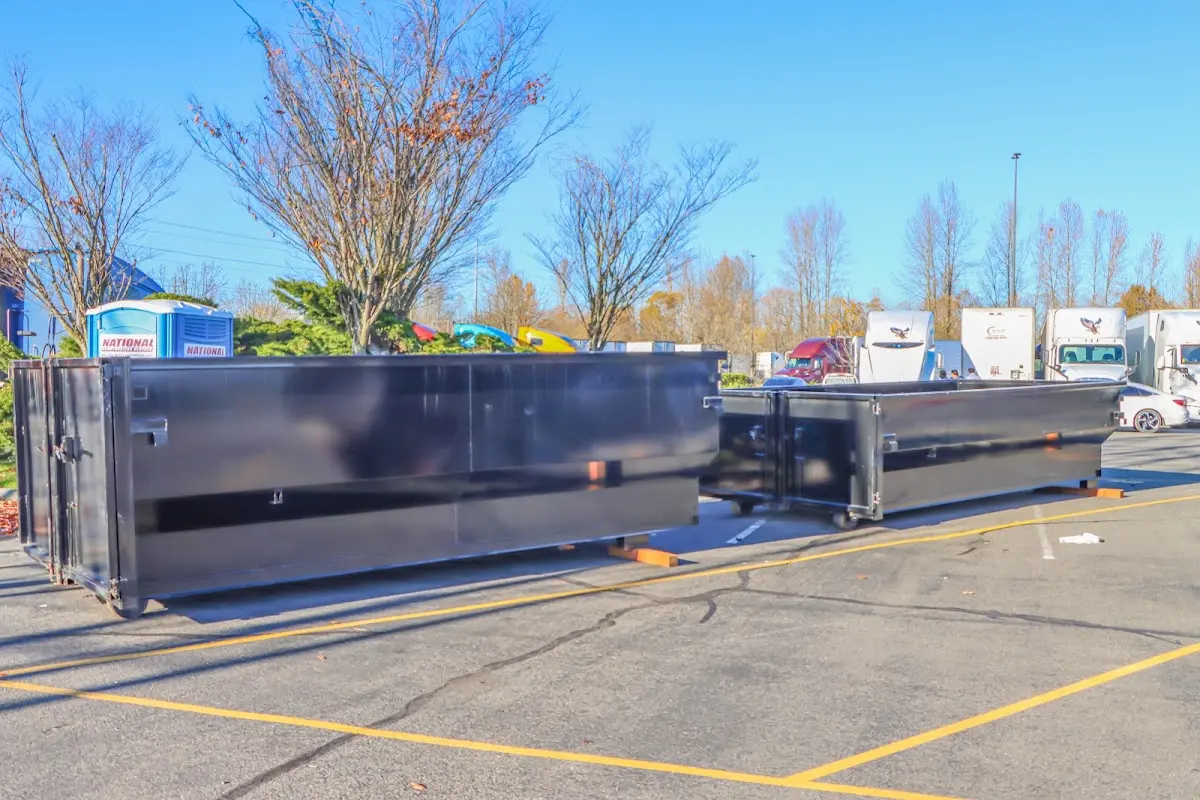 Professional dumpster rental service with roll-off container on residential driveway in Calcutta